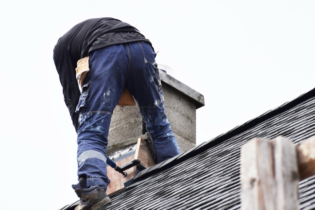 Charm City Masonry crew rebuilding a chimney stack in Towson, MD