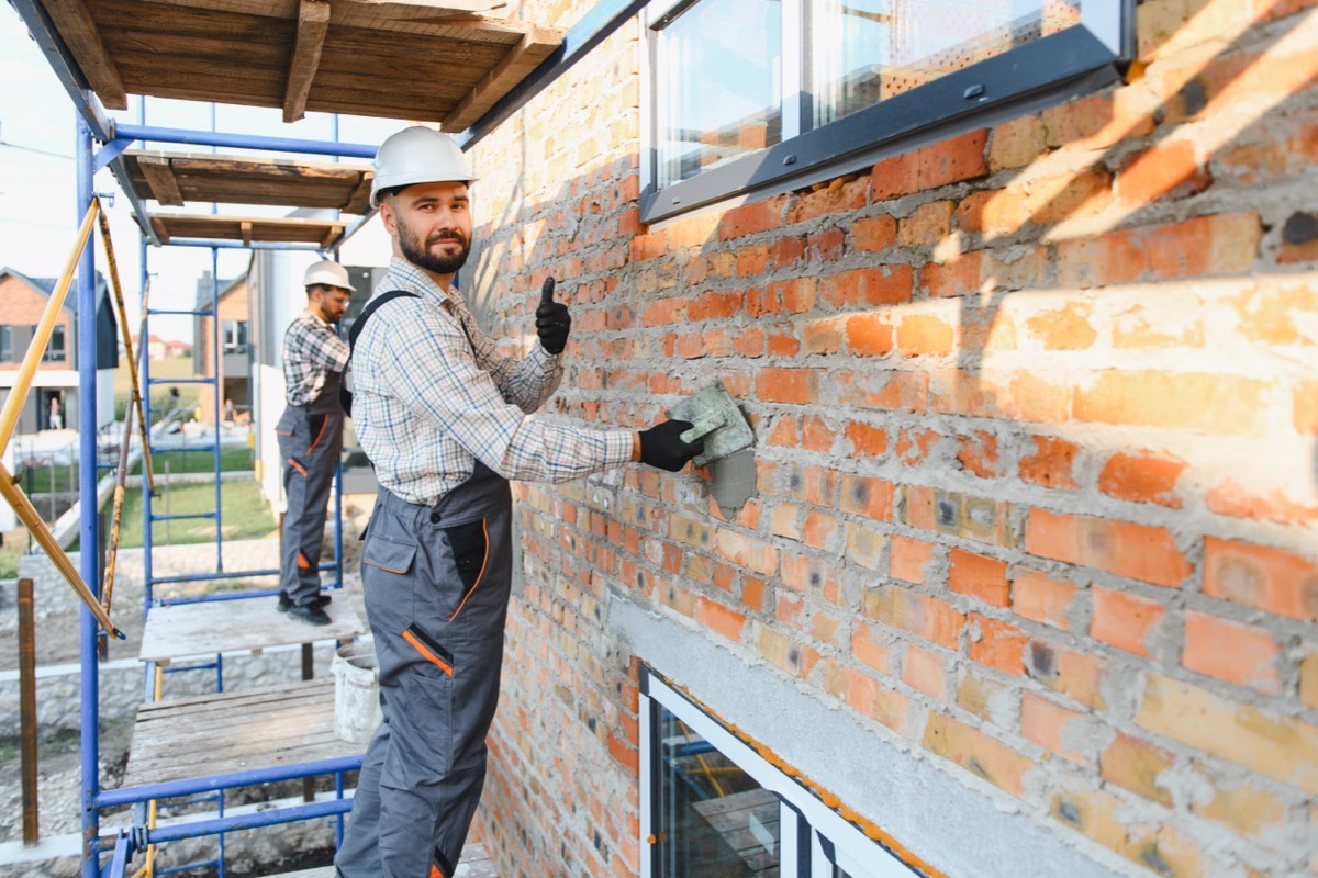 Charm City Masonry crew repointing a brick wall in Randallstown, MD