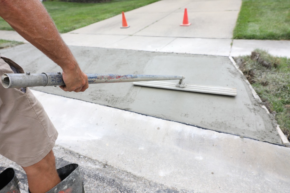 Charm City Masonry crew rebuilding concrete front steps on a Windsor Mill street