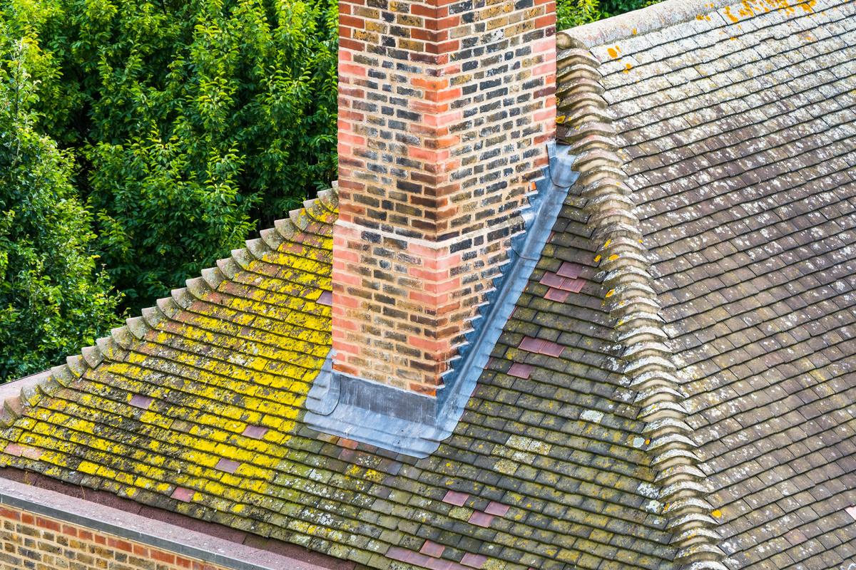 Eroded mortar joints on a Baltimore chimney above the roofline