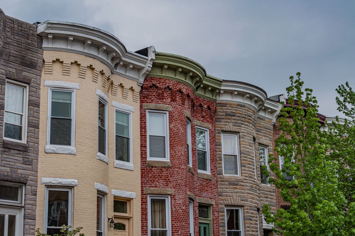 Formstone removal exposing damaged brick on a Baltimore rowhouse