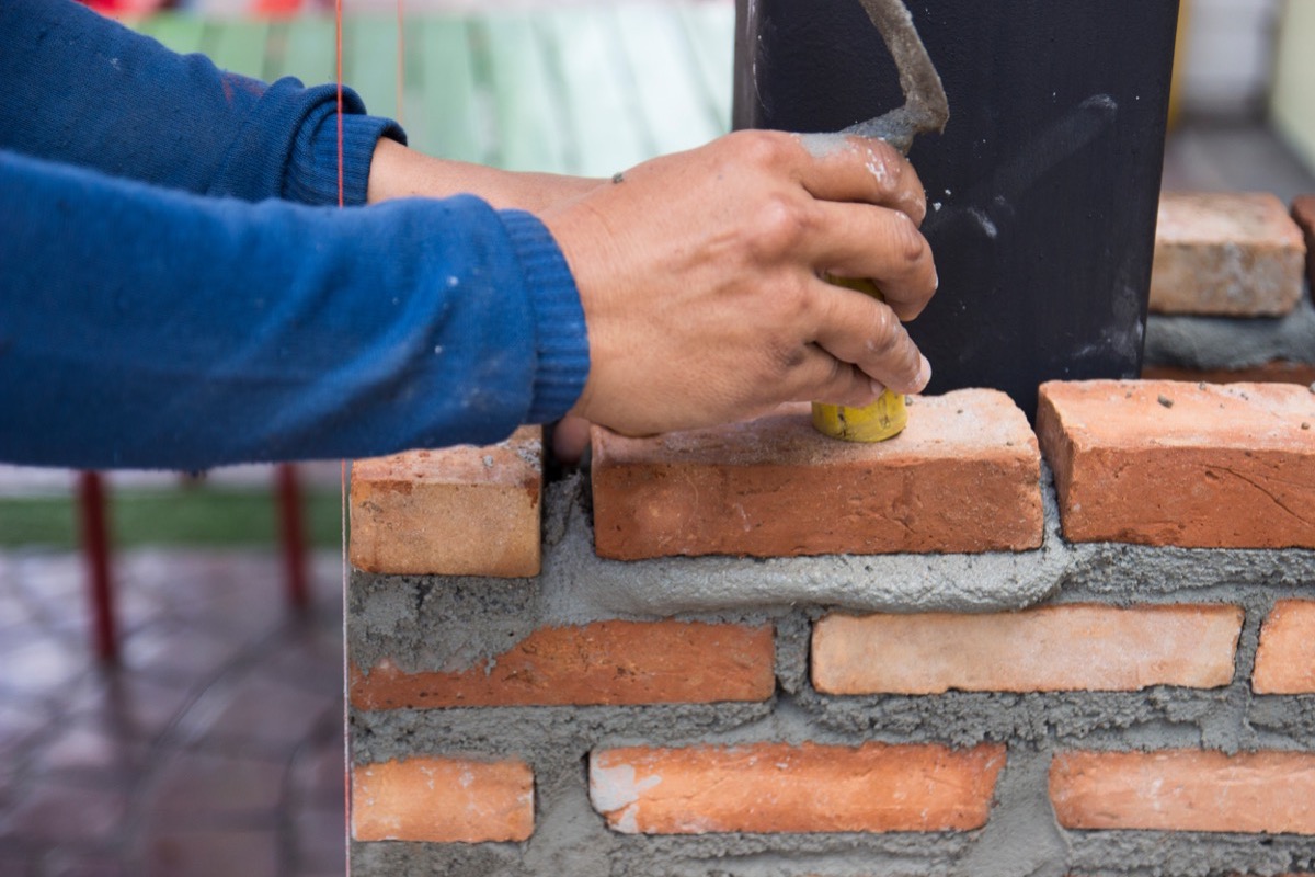 Mortar joints cut to depth and cleaned before repointing a Baltimore brick wall