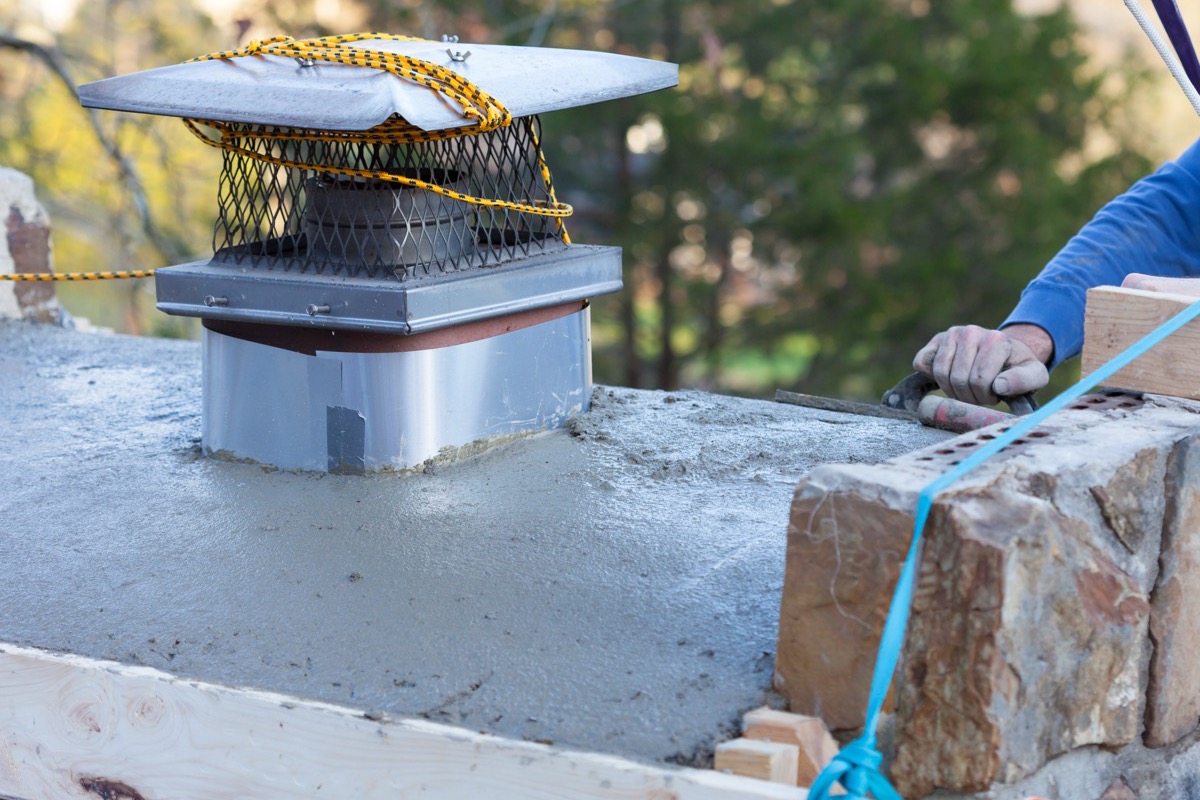 Newly cast chimney crown with an overhang and drip edge on a Baltimore chimney